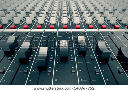 Closeup on a sliders of a mixing console. It is used for audio signals modifications to achieve the desired output. Applied in recording studios, broadcasting, television and film post-production.