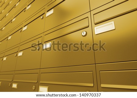 Side view on a wall of yellow metallic mailboxes. Useful for postal, shipment or correspondence realted purposes.