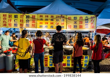 TAIPEI, TAIWAN - JULY 14: Hungry crowds eat at the Shilin Night Market food court in the Shilin District of Taipei July 14, 2013. Shilin Market is the most popular and largest night market in Taiwan.