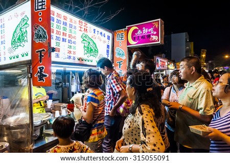 Kenting, Taiwan - JULY 15, 2015: Vendor prepares food at the Kenting main street night market located in Pingtung County.