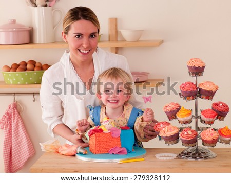 Mother with Daughters decorating cakes