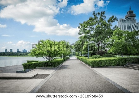 Similar – Image, Stock Photo Country road and path surrounded by fields with barley and rape, two trees standing at the roadside in front of a blue sky with little clouds and sunshine