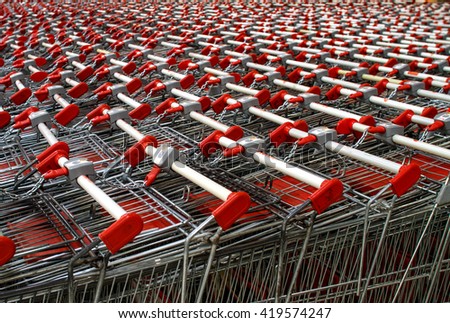 Similar – Image, Stock Photo Lined up shopping trolleys made of shiny wire with red plastic in front of a new supermarket in Bielefeld in the Teutoburg Forest in East Westphalia-Lippe