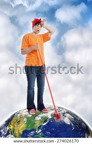 Mature caucasian woman trying to clean the Earth, photo of the Earth from NASA