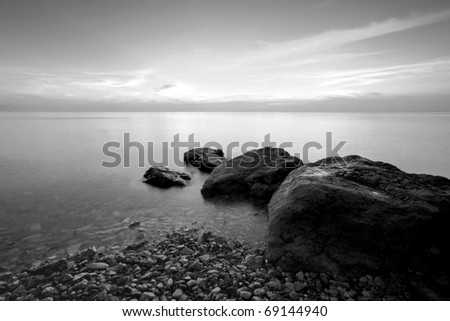 Long exposure photo of beach in the evening, black and white