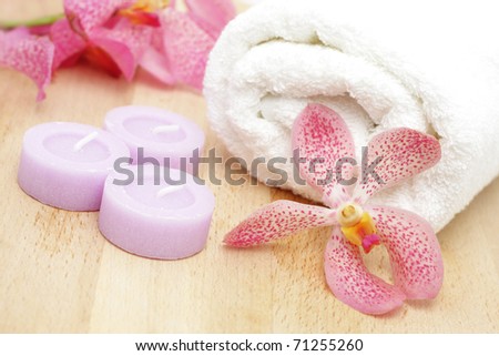 Tealight candles and white towel with orchids