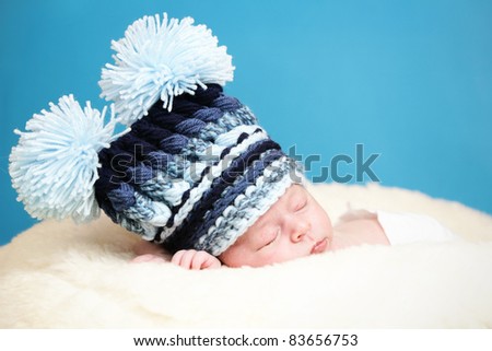Adorable newborn with big knitted hat