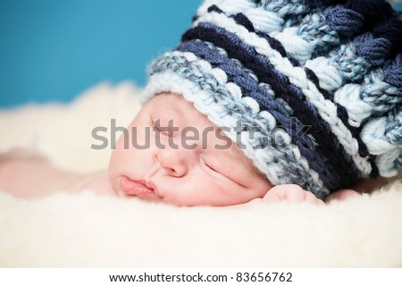 Adorable newborn with big knitted hat