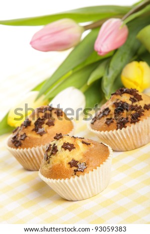 Home baked muffins with tulips in background