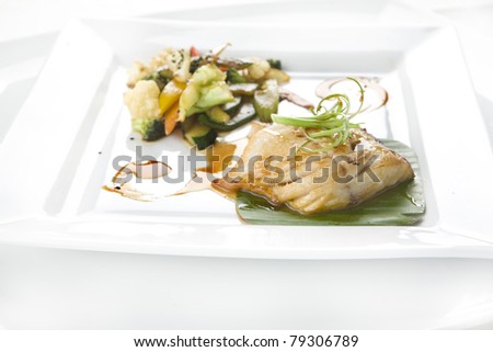 a dish of fillet of fish with steamed vegetables