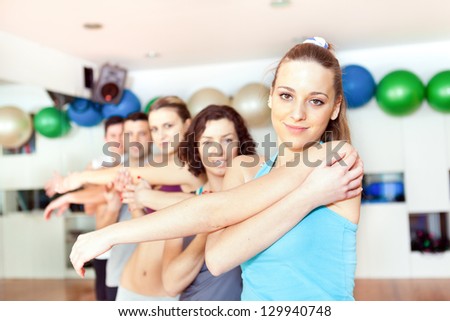 Group of people stretching at the gym