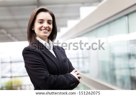Portrait of a well-dressed young business woman with cross-armed
