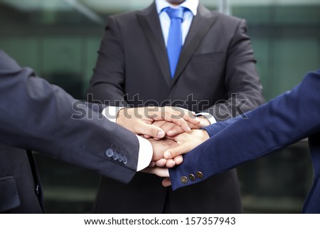Business team showing union with their hands together forming a pile