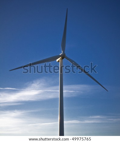 white wind turbine and blue sky, alternative energy source