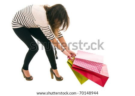 Beautiful stylish woman pulling shopping bags