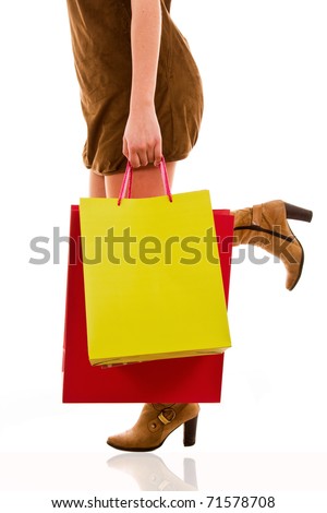 waist-down view of woman carrying shopping bags