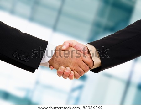 Closeup picture of businesspeople shaking hands, making an agreement.
