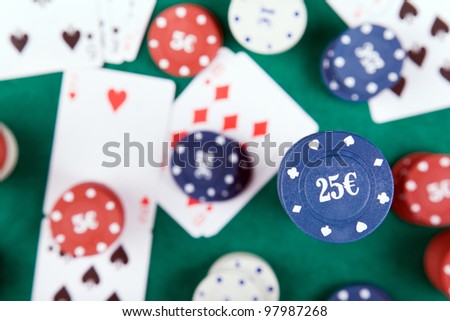 Poker chips and cards on a green felt
