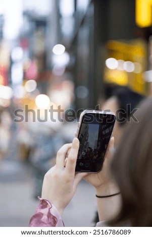 Similar – Image, Stock Photo Female tourist taking shot of sea in twilight