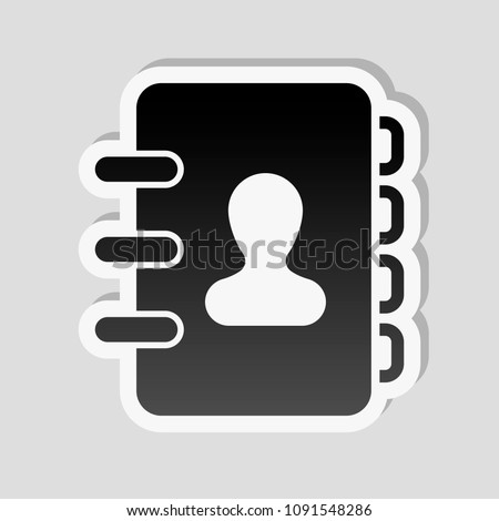 address book with person on cover. simple icon. Sticker style with white border and simple shadow on gray background