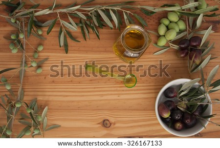 Olive branches on wood with Olive Oil