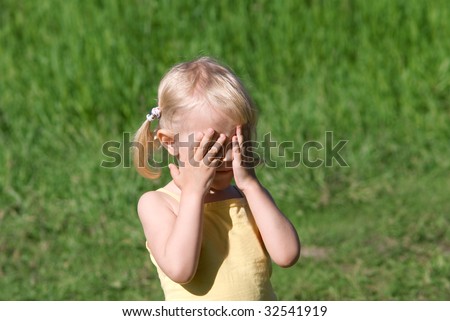 Little girl covering her eyes