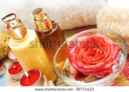 Spa pampering in the bathroom with candles and rose