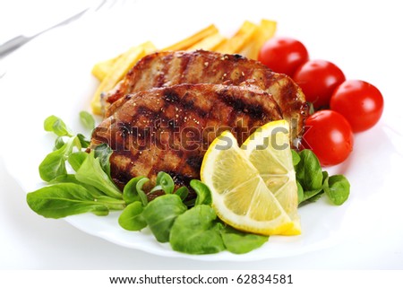 Grilled steak meat on a white plate on white isolated background