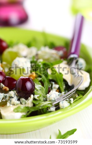 Fresh salad with grapes, blue cheese and goat cheese, dressing with walnut
