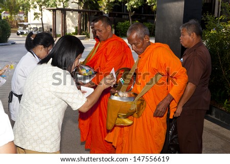 BUDDHIST MONKS,PHUKET, THAILAND - MARCH 22: Buddhist monks seeking Alms at western hotels, Thailand, March 22nd, 2013, Phuket, Thailand. Alms for the poor