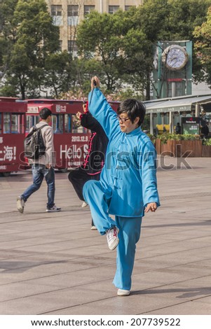 SHANGHAI, CHINA - 28 MARCH 2014: Nanjing road where people practice Tai Chi in the mall every morning