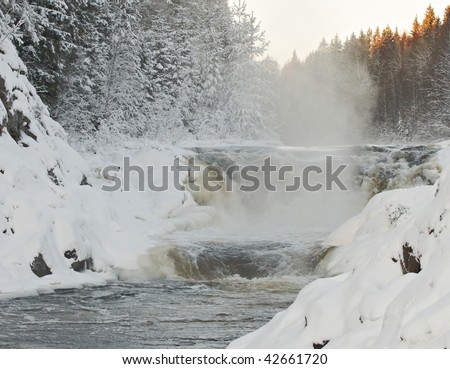 Kind on falls of Kivach in Kareliya in a winter icy cold