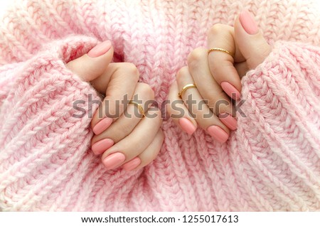 Nail Polish. Art Manicure. Modern style pink Nail Polish.Stylish pastel Color pink Nails holding wool material sleeve blouse . Classic wedding bride nails design