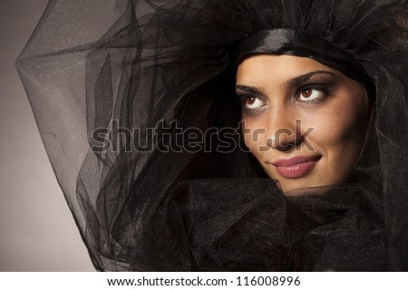 Portrait of a a beautifull smiling young woman in black veil