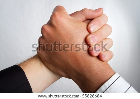 Two caucasian business partners holding hands