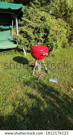 Red Barbeque on grass in garden Stok fotoğraf © 