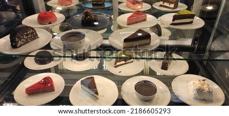 Beautiful cake and dessert plates in bakery window display Stok fotoğraf © 
