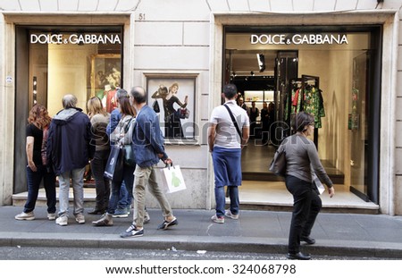 ROME, ITALY - OCTOBER 03 2015: People looking at Dolce & Gabbana show window at Via Condotti in Rome, Italy