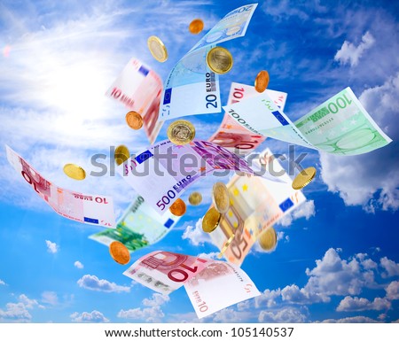 Euro banknotes and coins falling from blue sky