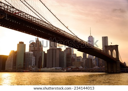 Manhattan skyline with Brooklyn Bridge at sunset, New York City