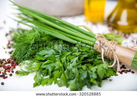 bunches of fresh herbs and oil