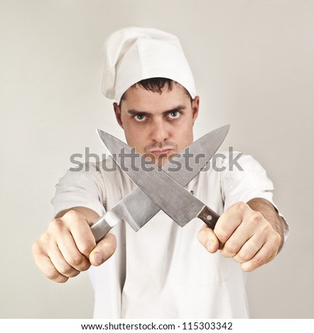 Chef sharpening two knives against each other crossing over them - a symbol of prohibition and restriction diet