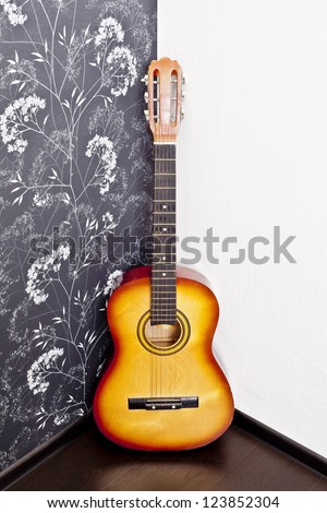 Spanish guitar on wall, copy spaced.