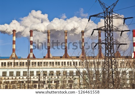 factory with smoke coming out of chimneys.
