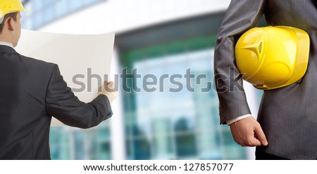 engineer yellow helmet for workers security over modern building