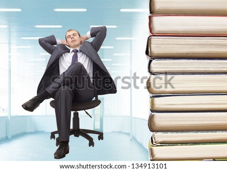 business Man sitting on chair with stack of books    idea - knowledge - force