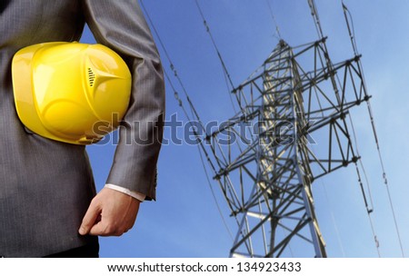 engineer yellow helmet for workers security over high voltage power line