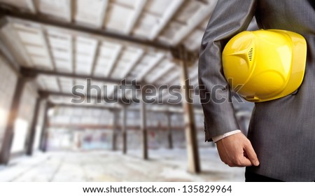 engineer yellow helmet for workers security over empty warenhouse background