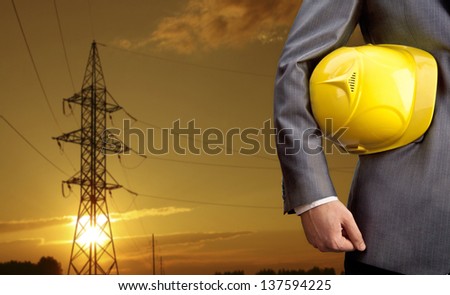 engineer yellow helmet for workers security over high voltage power line