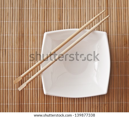 The rectangular white plate on a bamboo stand